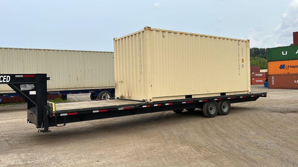 Shipping container secured on Red Shark Transport flatbed gooseneck