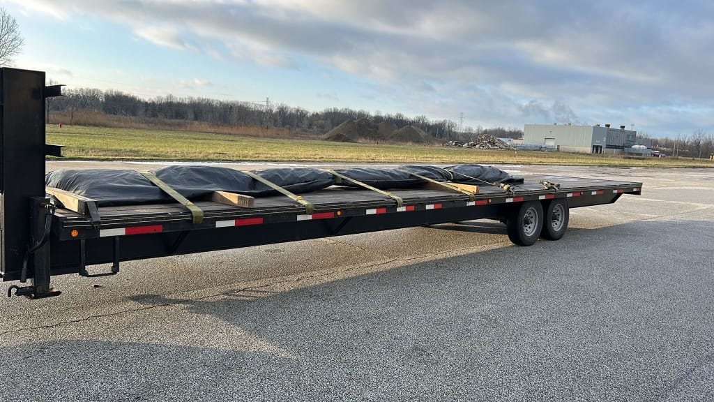 Red Shark Transport gooseneck with tarped hotshot load
